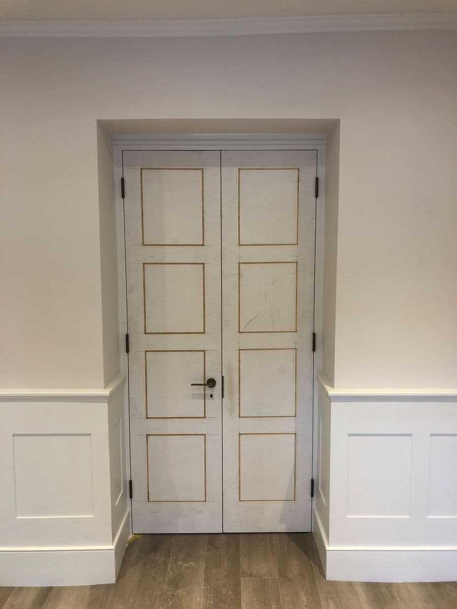 Panelled hallway with a fitted door