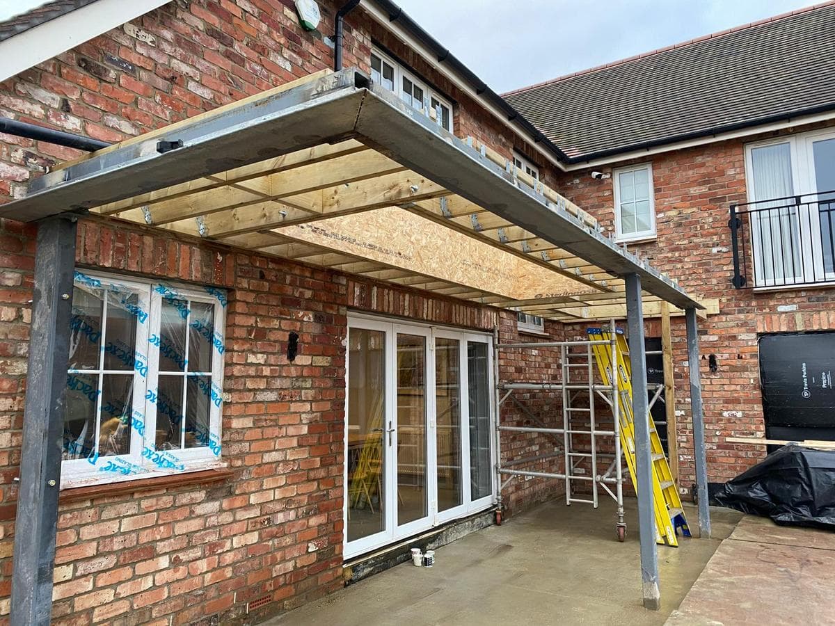 Completed steel and timber veranda across the rear of a brick house