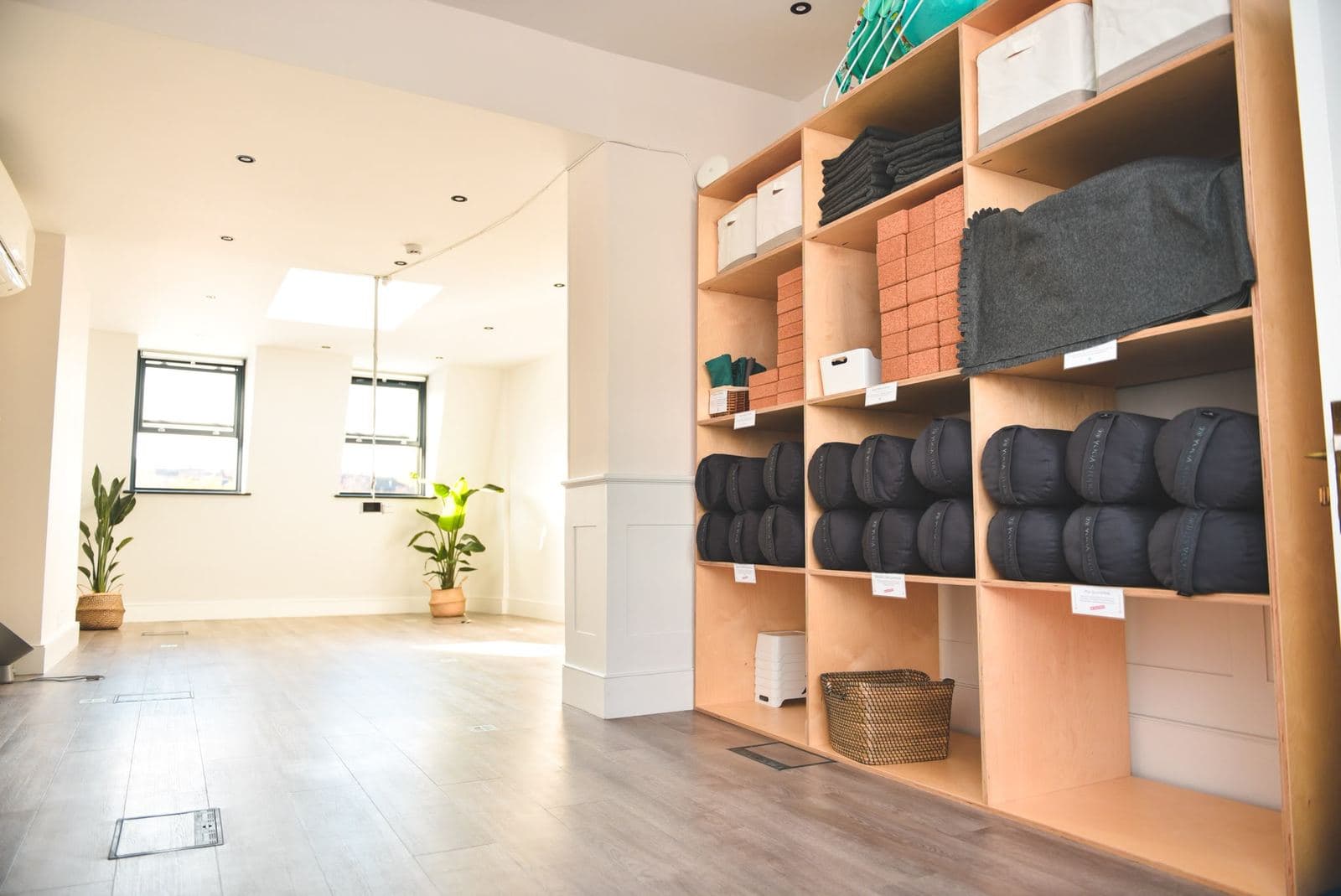Finished yoga studio floor with prop shelving along one wall