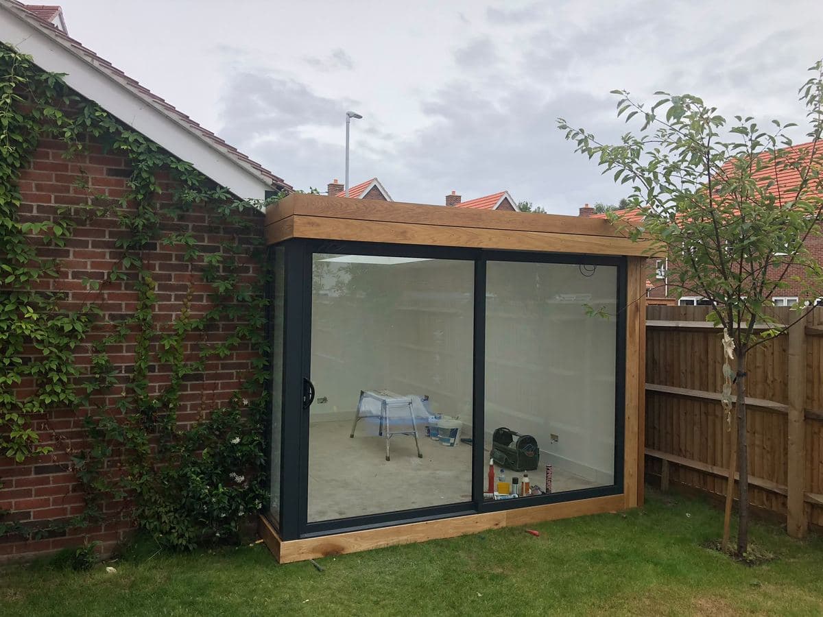 Cedar clad garden room with a full glazed corner