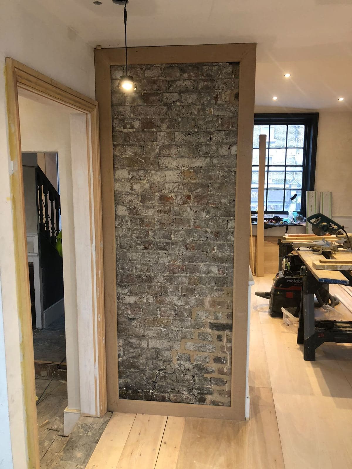 Original brick pier and restored door surround on the landing