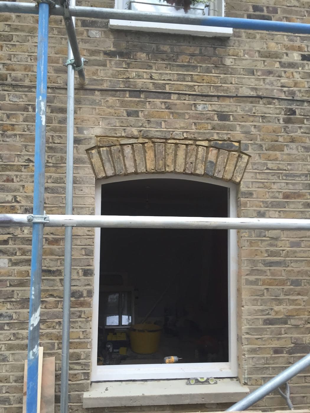 Restored sash window with an arched brick head