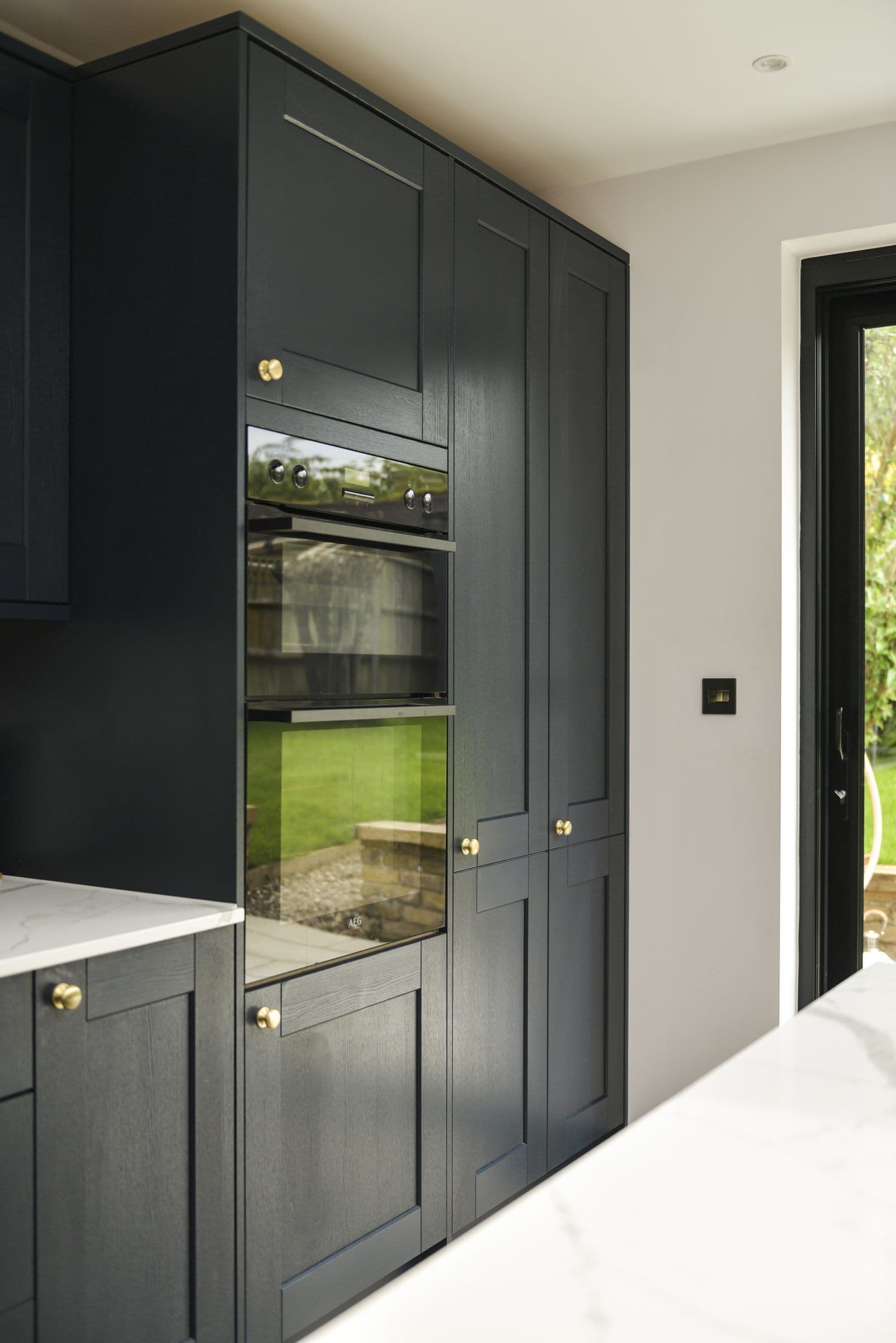 Tall cabinetry run with oven housing, scribed to the wall