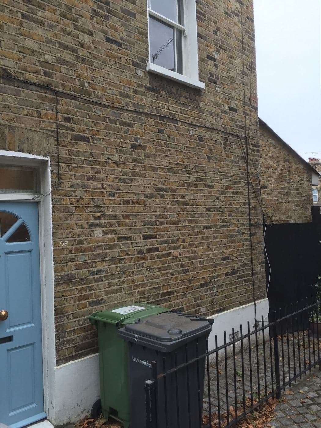 Restored terrace house facade with a period front door