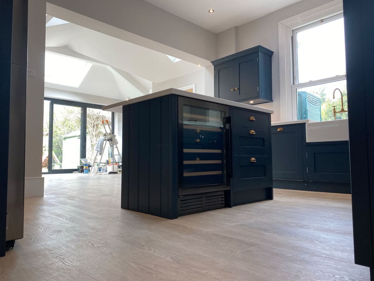 Navy shaker kitchen island with a wine cooler