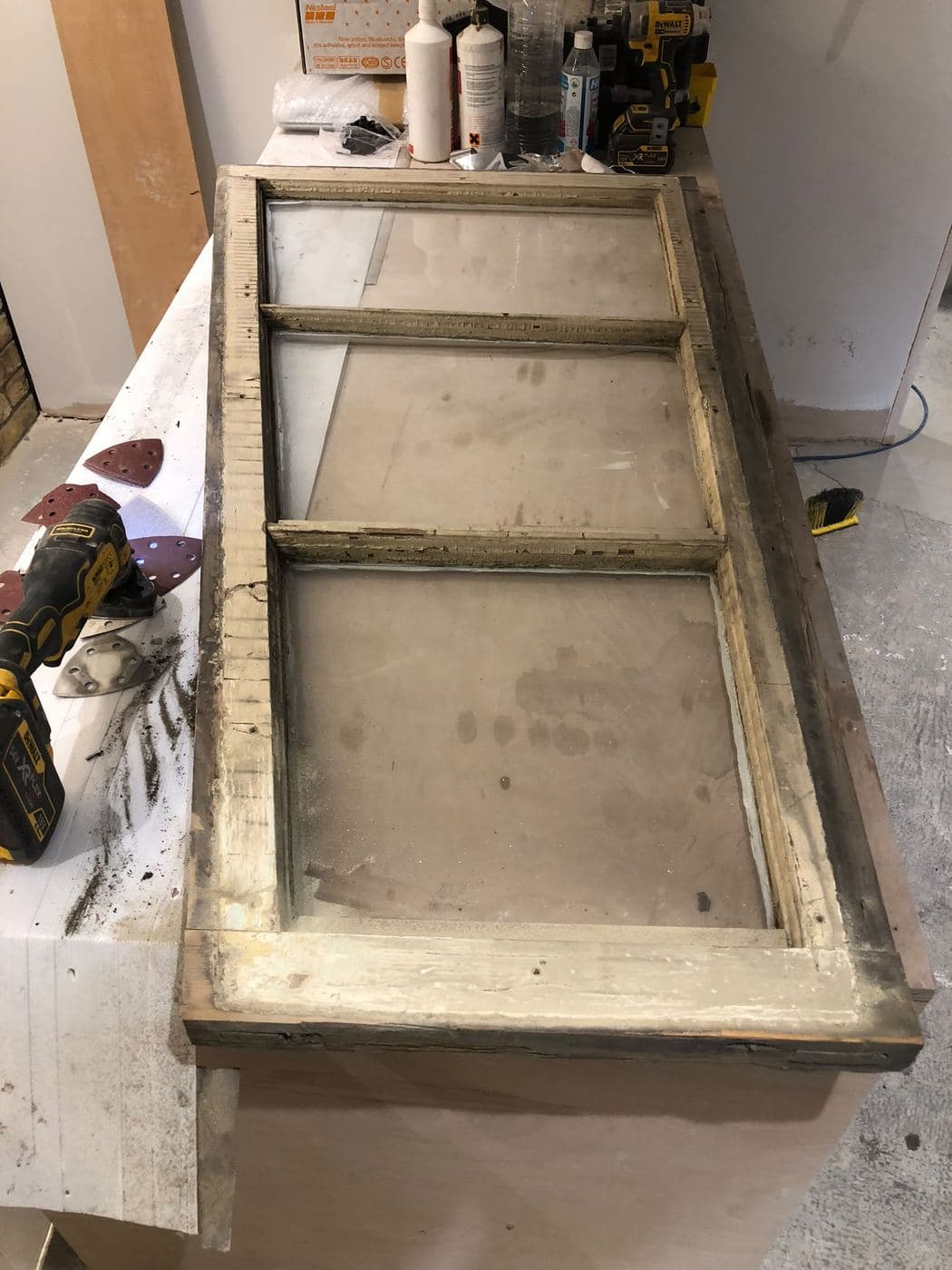 A sash window stripped back on the bench for repair