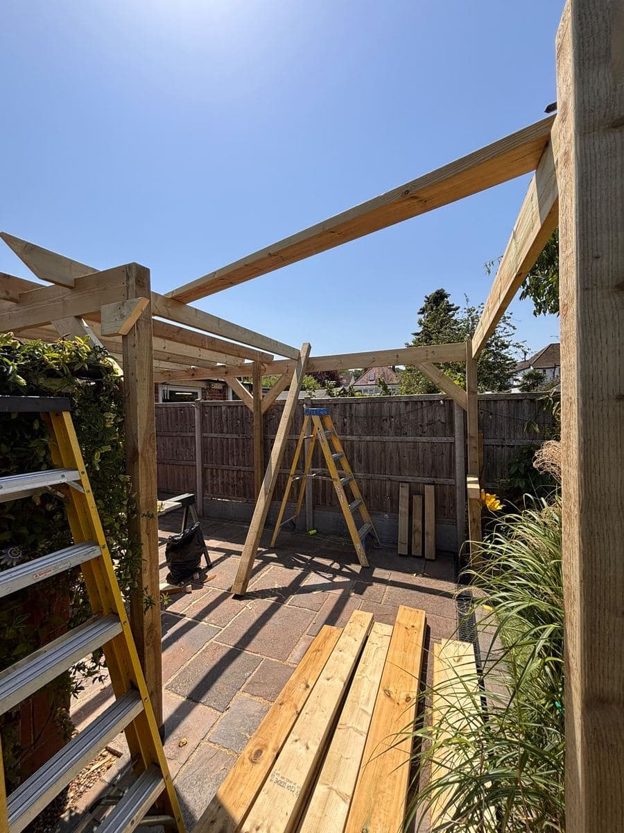 Timber pergola forming a walkway down a garden
