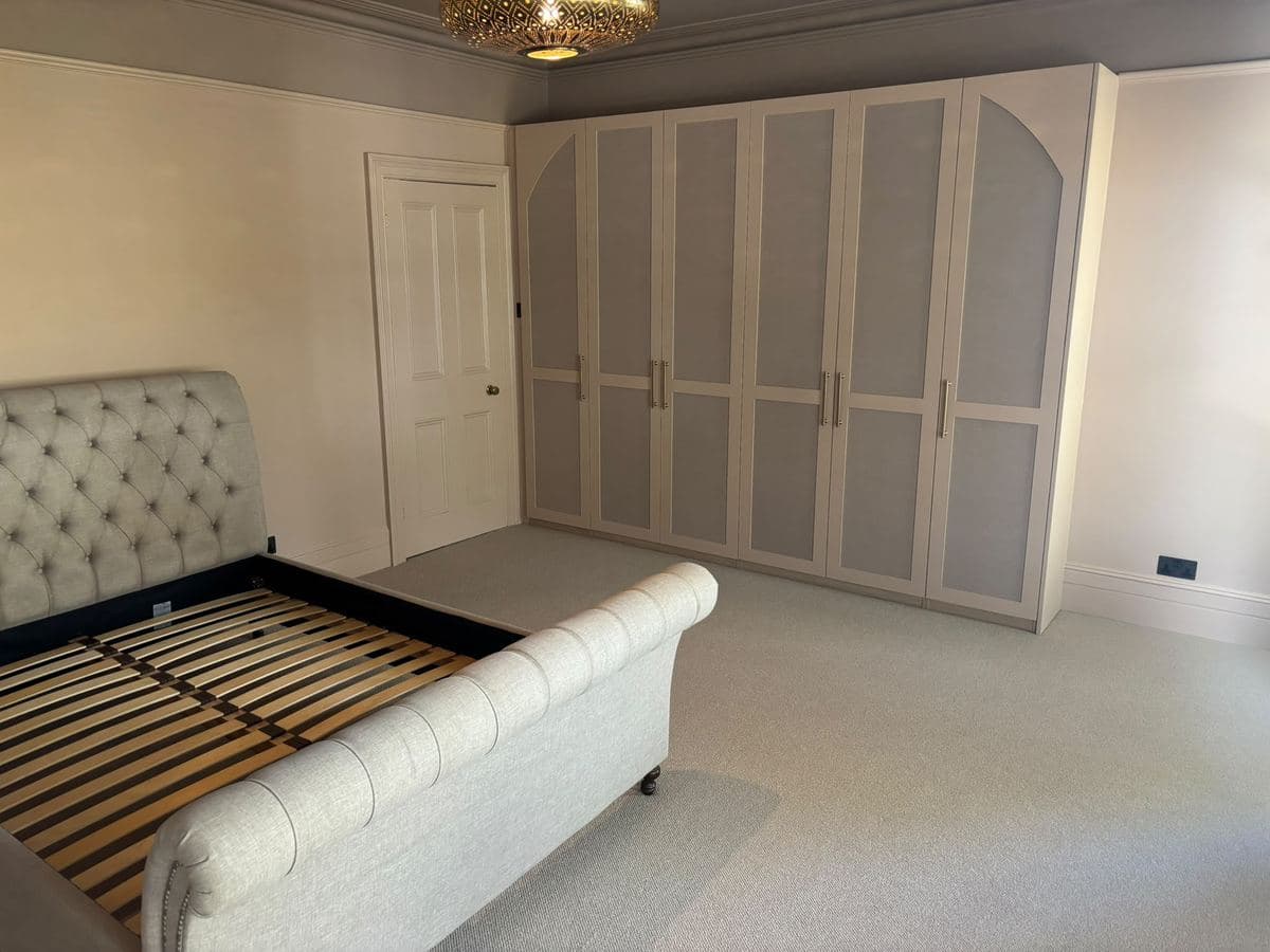 Full wall of fitted wardrobes in a bedroom