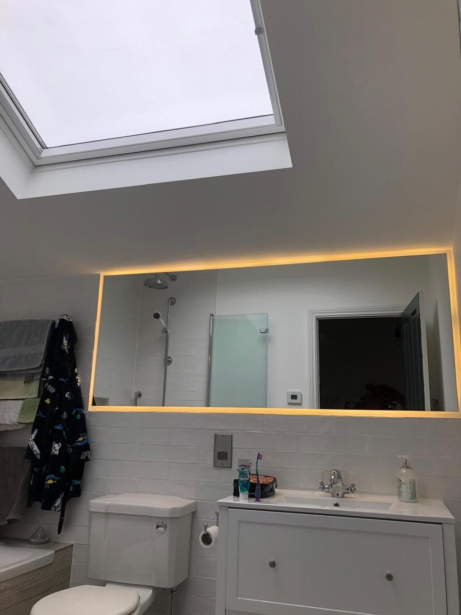 Bathroom with lit mirror