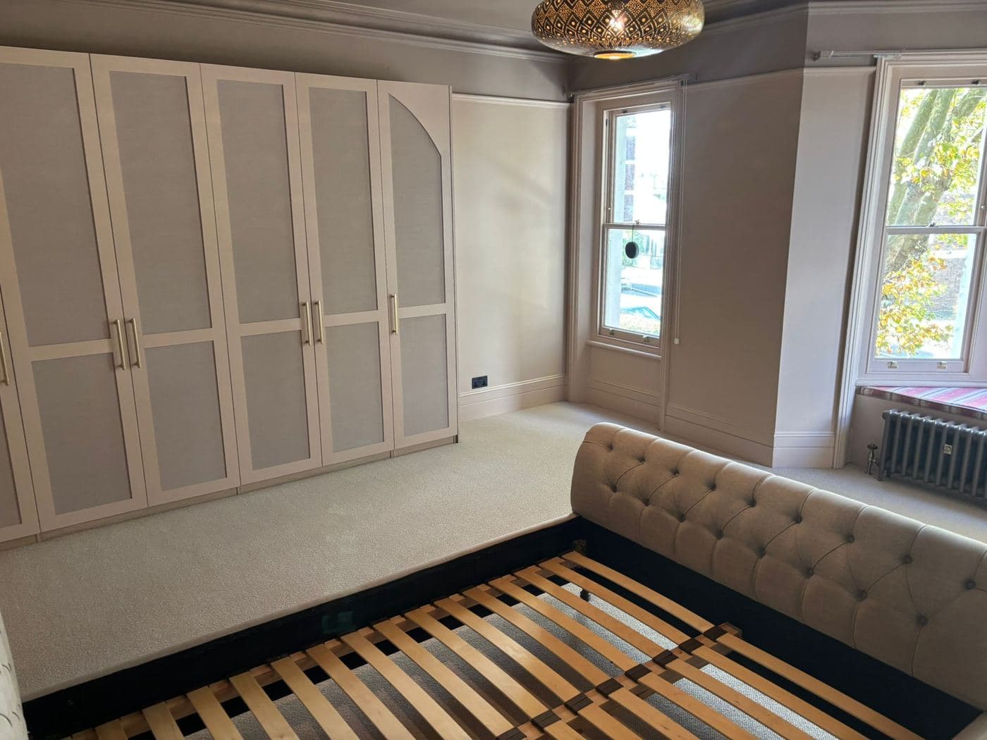 Fitted wardrobes and a window seat in a bedroom