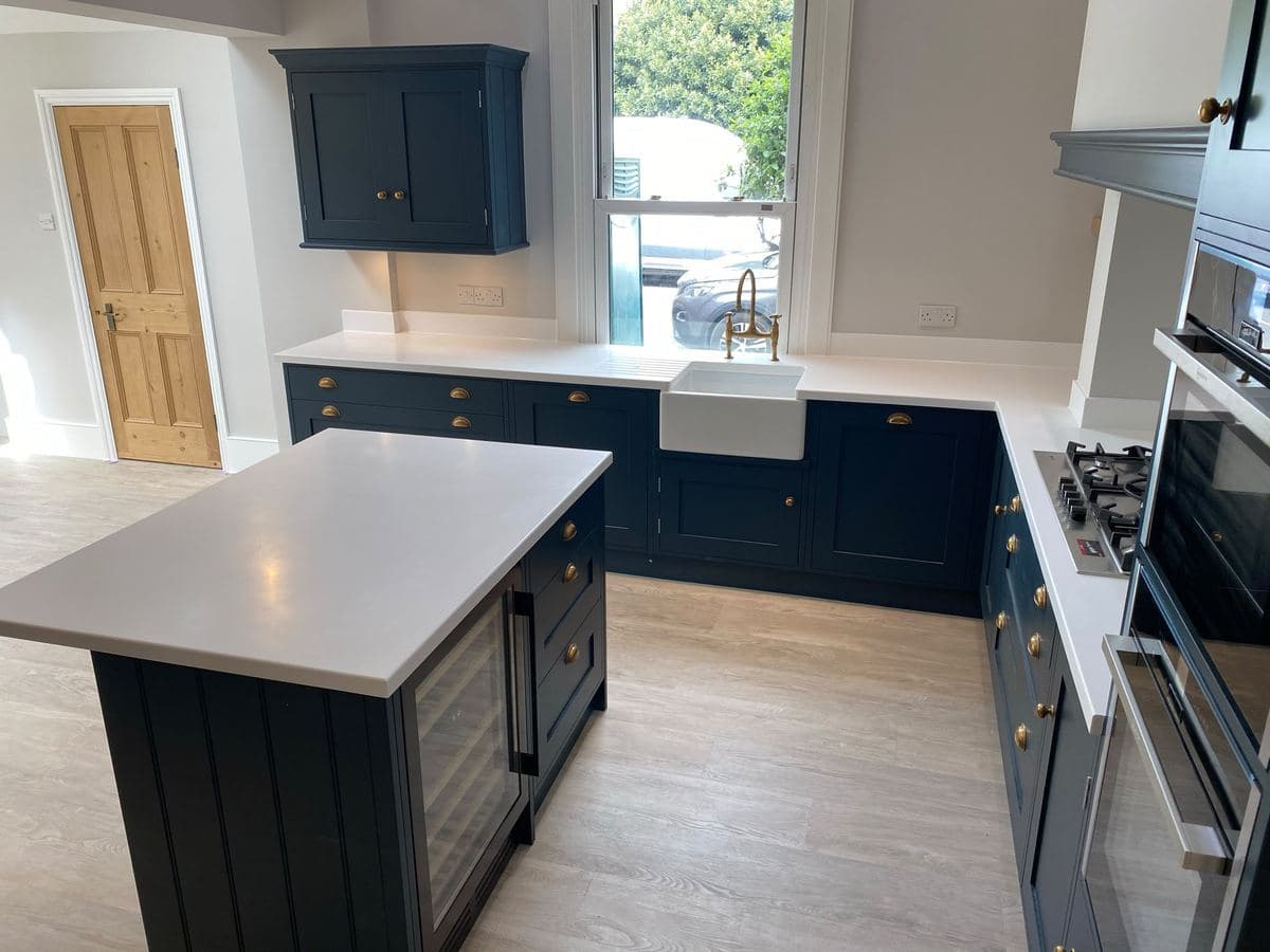 Navy shaker kitchen with an island and bifold doors to the garden