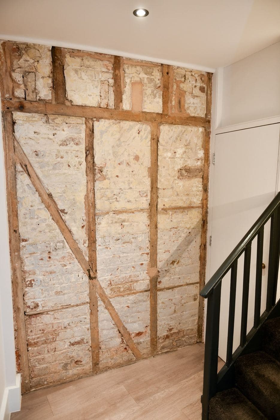 Original timber stud frame exposed under a staircase during restoration