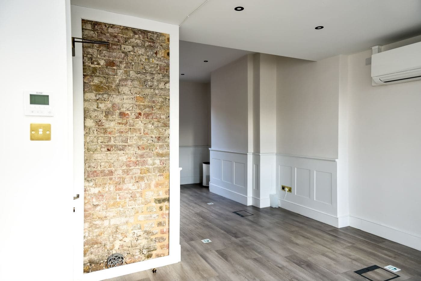 Ground floor room with a full exposed brick feature wall