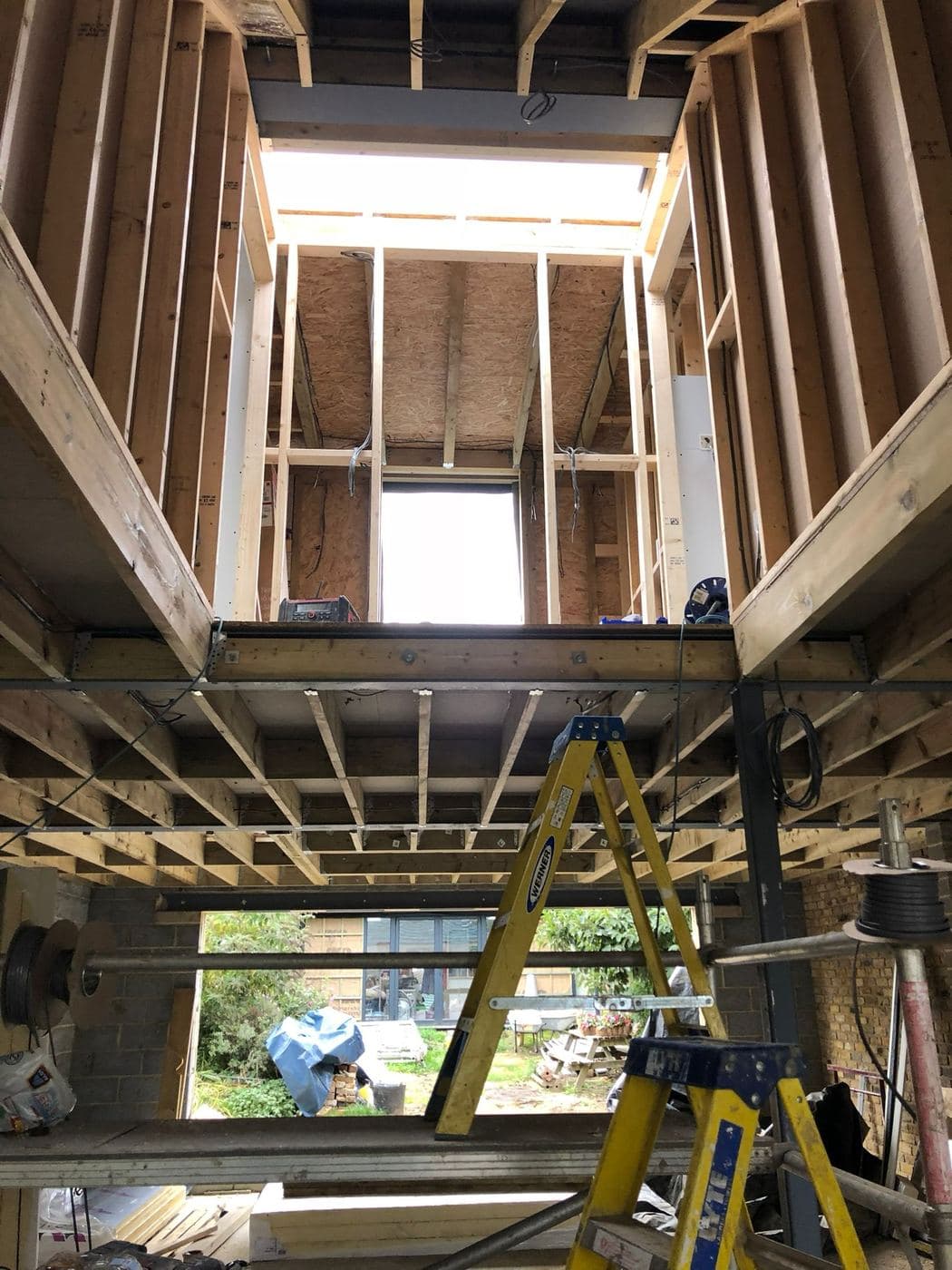 Double height timber floor and roof structure under construction