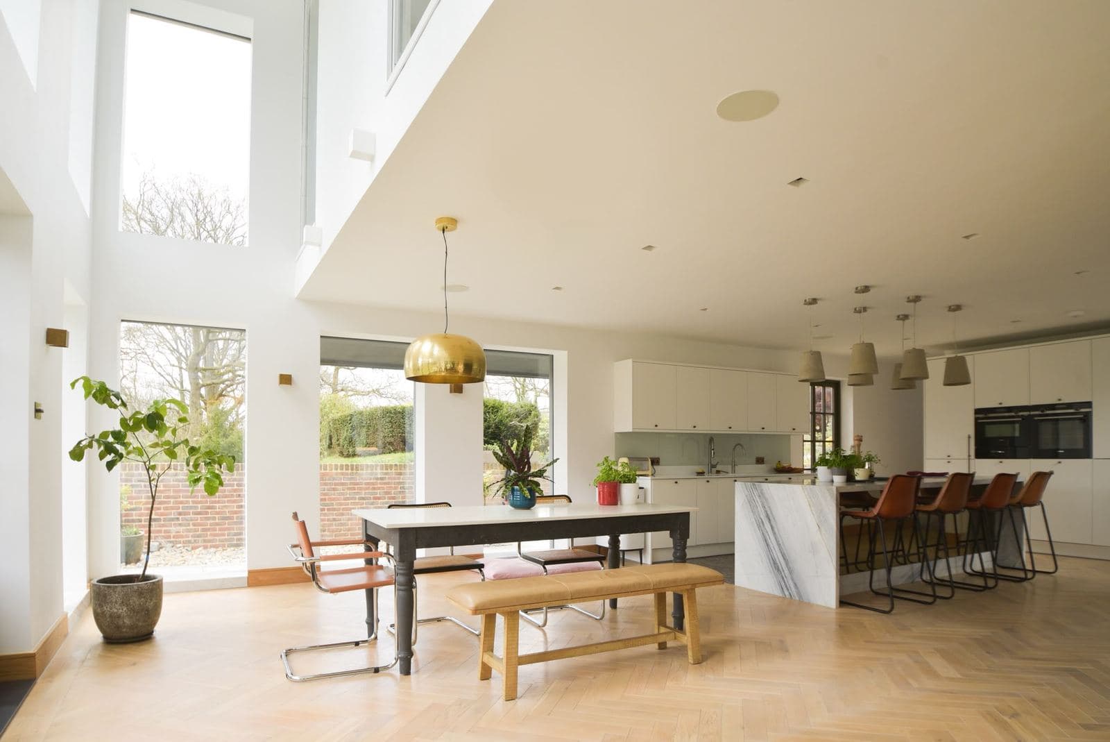 Vaulted family room lit by rooflights, herringbone floor