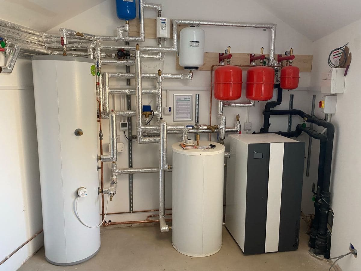Plant room housing the hot water cylinder and manifolds