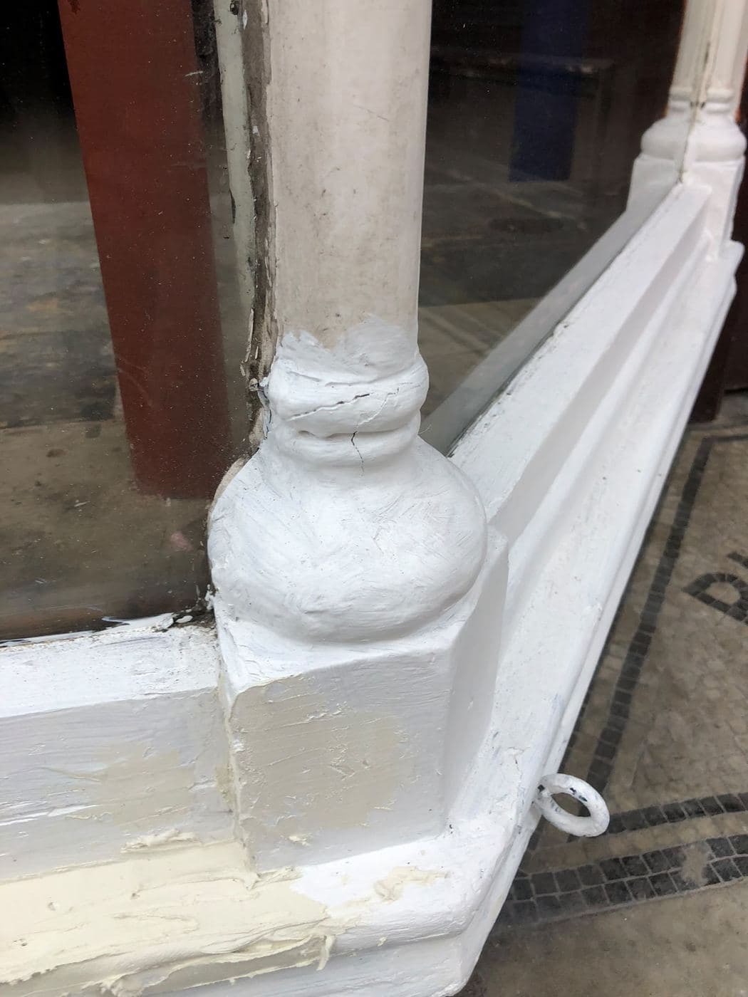 Restored painted staircase newel post and handrail