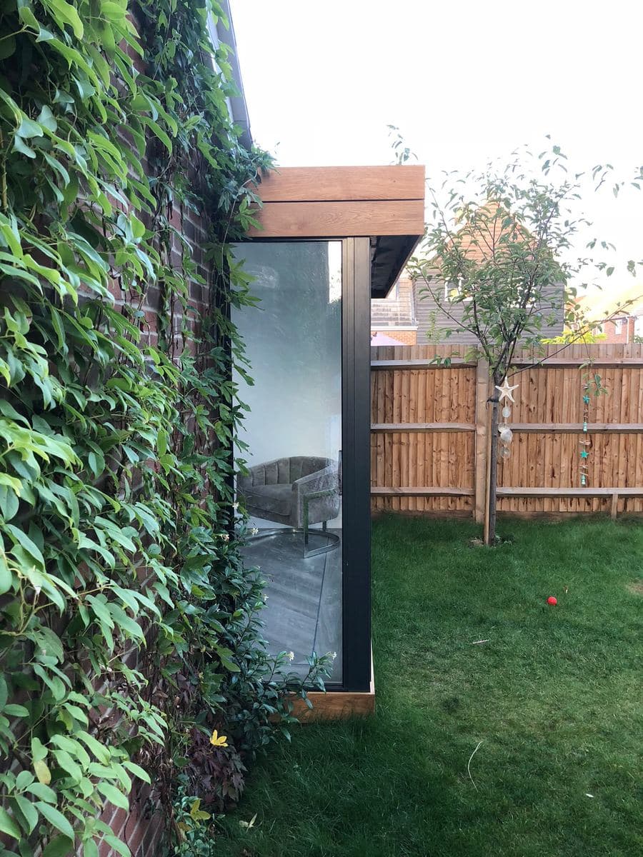 Garden room beside a wall covered in ivy