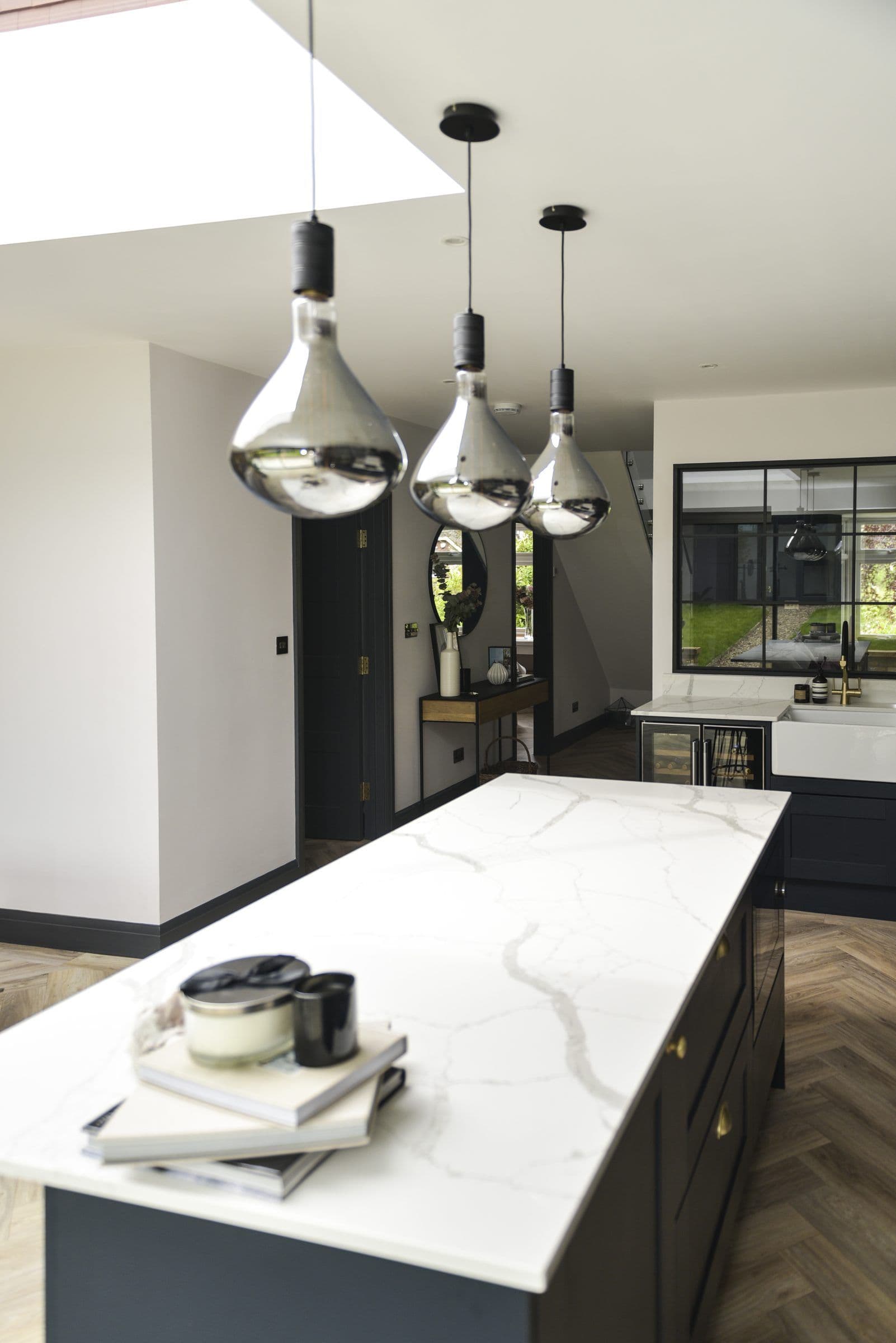 Kitchen island under pendant lights, fitted by RSW Carpentry