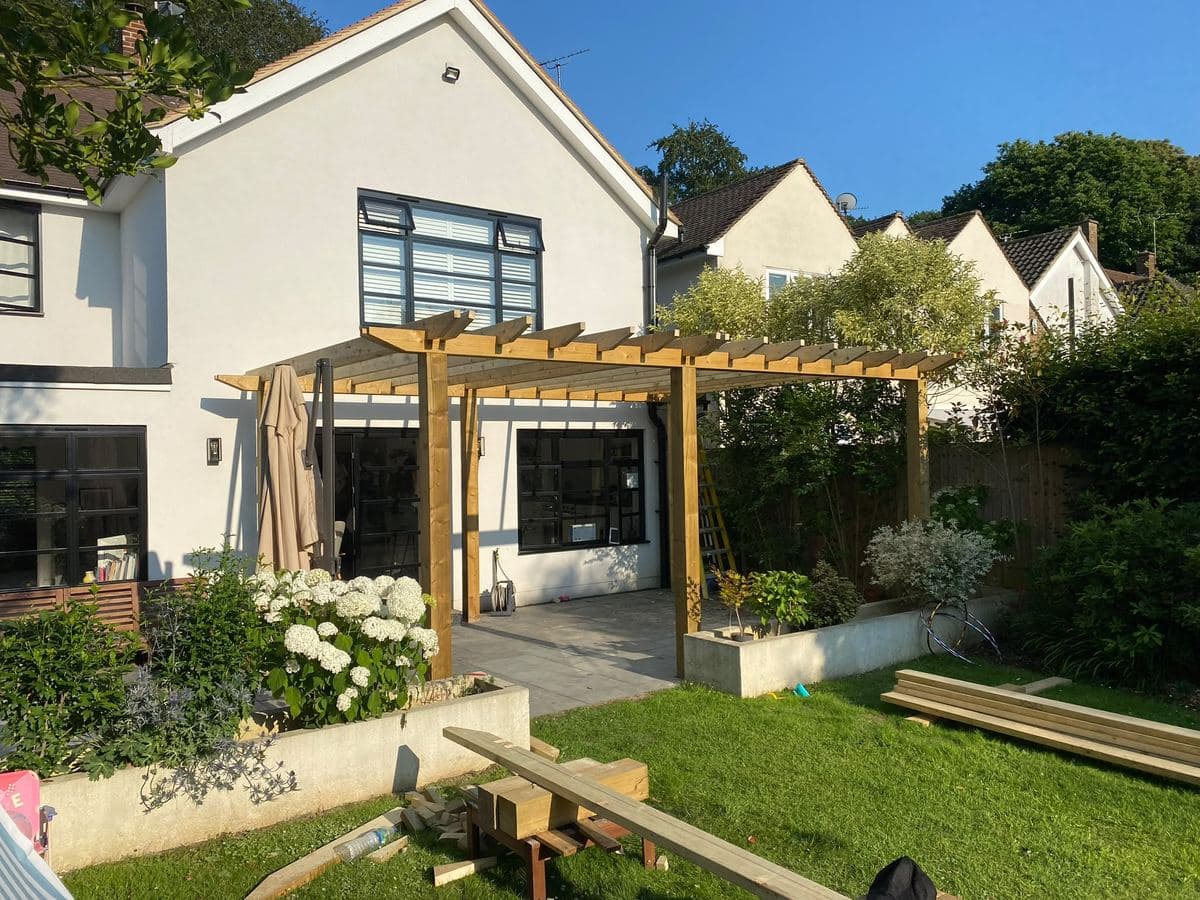 Timber pergola against the rear of a house
