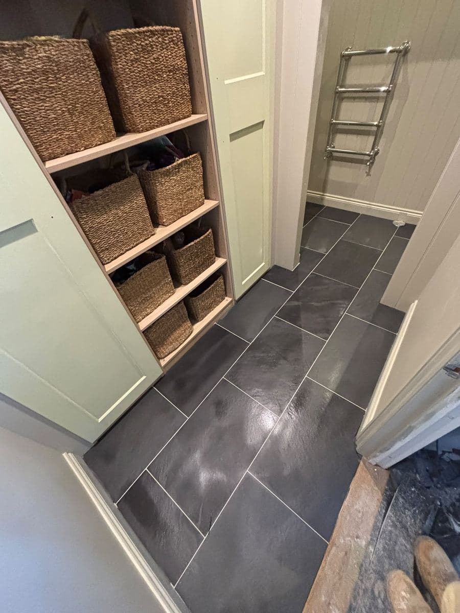 Fitted boot room shelving with baskets and tiled floor