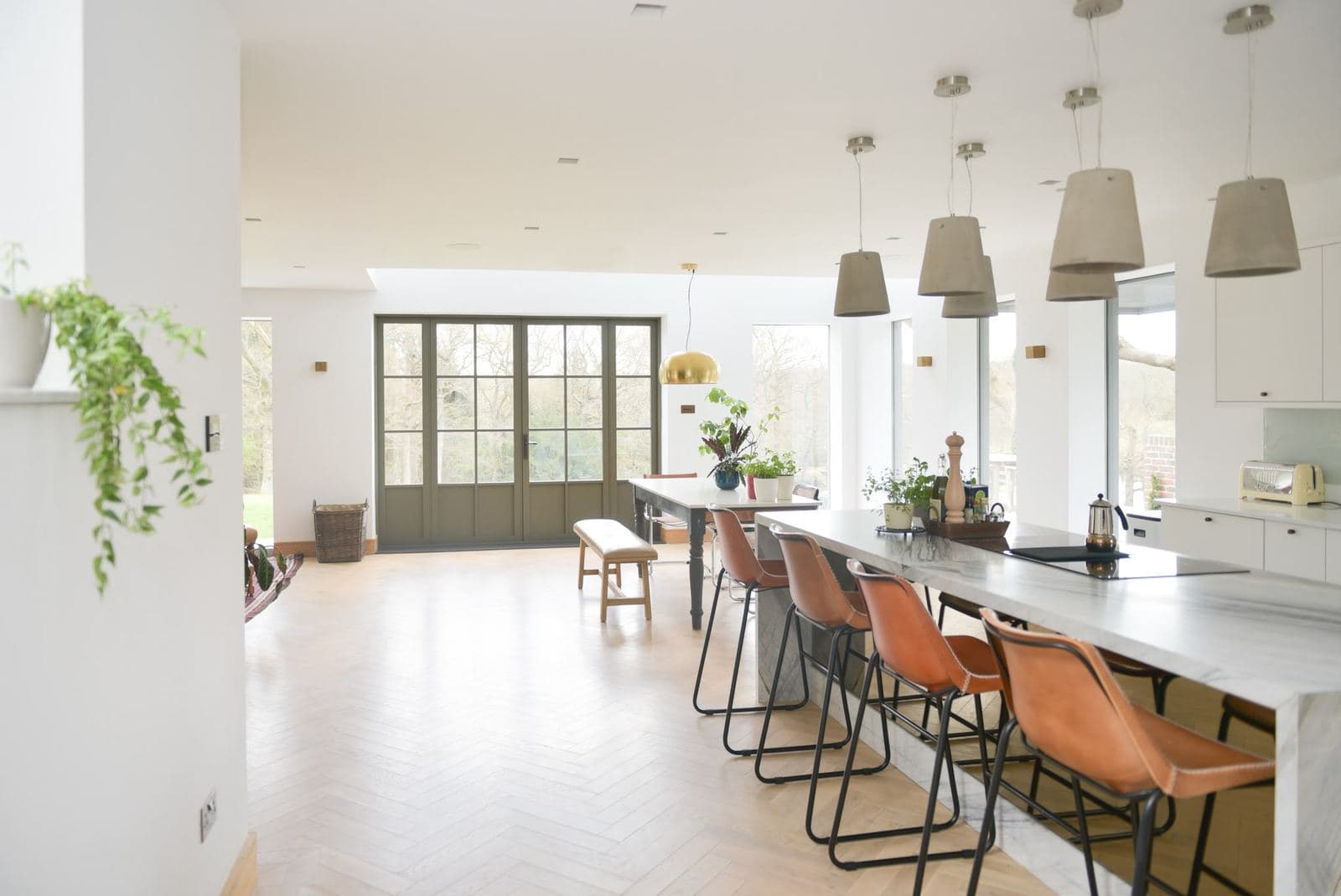 Finished open plan kitchen and dining room with herringbone floor
