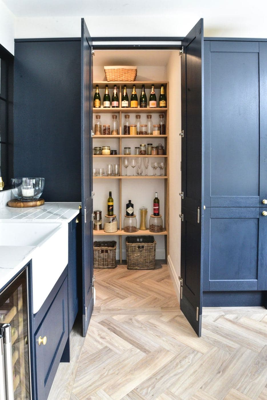 Walk in pantry with open shelving for bottles and glassware